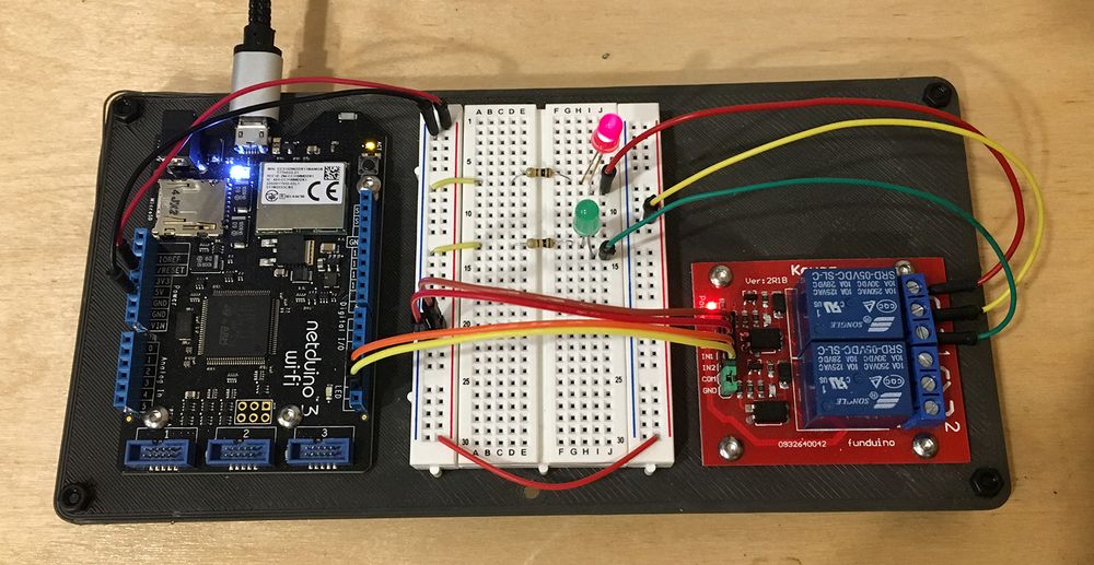 Photo of a physical version of the above diagram, a Netduino board connected to a breadboard and two-channel relay.