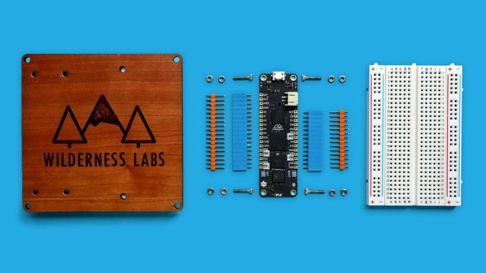 Meadow developer kit parts: mounting protoboard, Meadow board with headers and mounting hardware, and small breadboard.